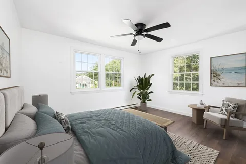 a bed sitting in a bedroom next to a window