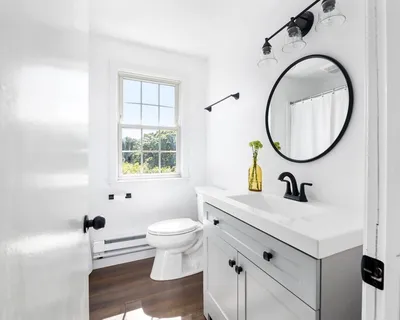 a bathroom with a sink toilet a mirror and tub