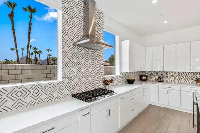 a kitchen with a sink a stove and cabinets