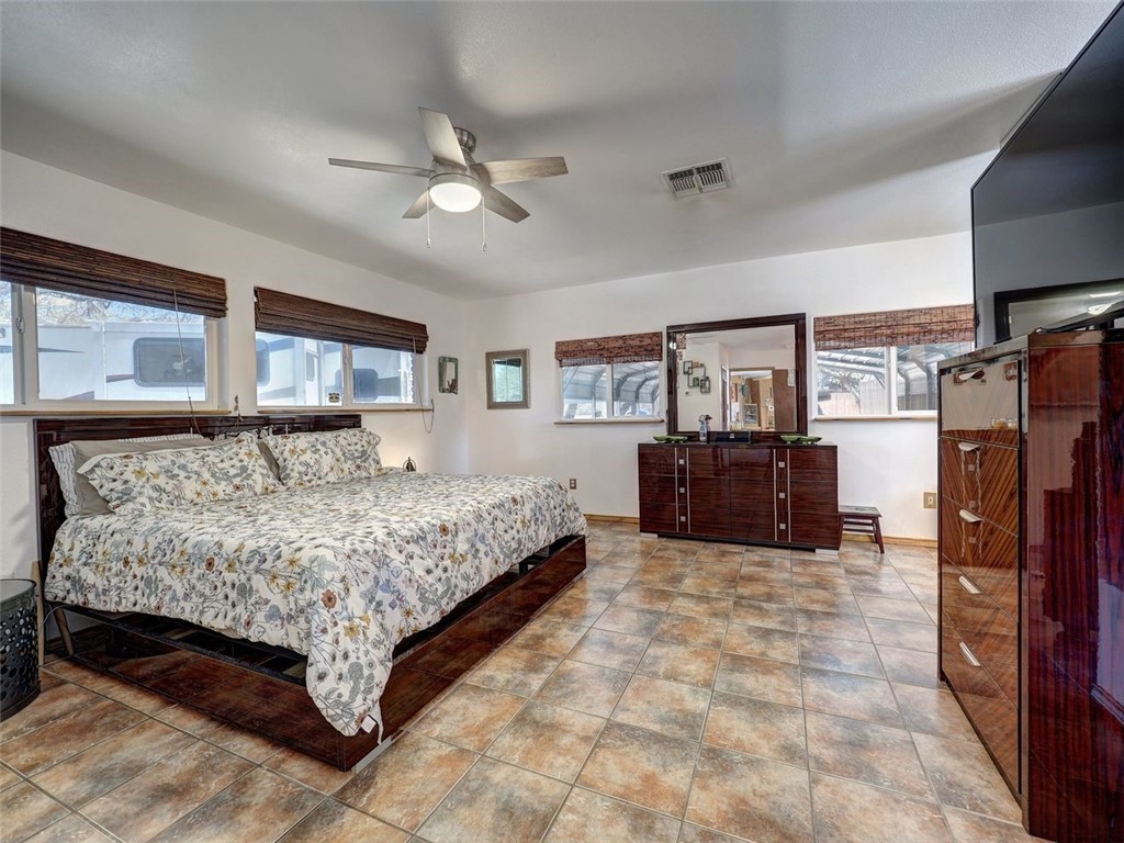 202 Sunset Ingleside, TX 78362 - Photo 11 of 40 a spacious bedroom with a bed dresser and a flat screen tv