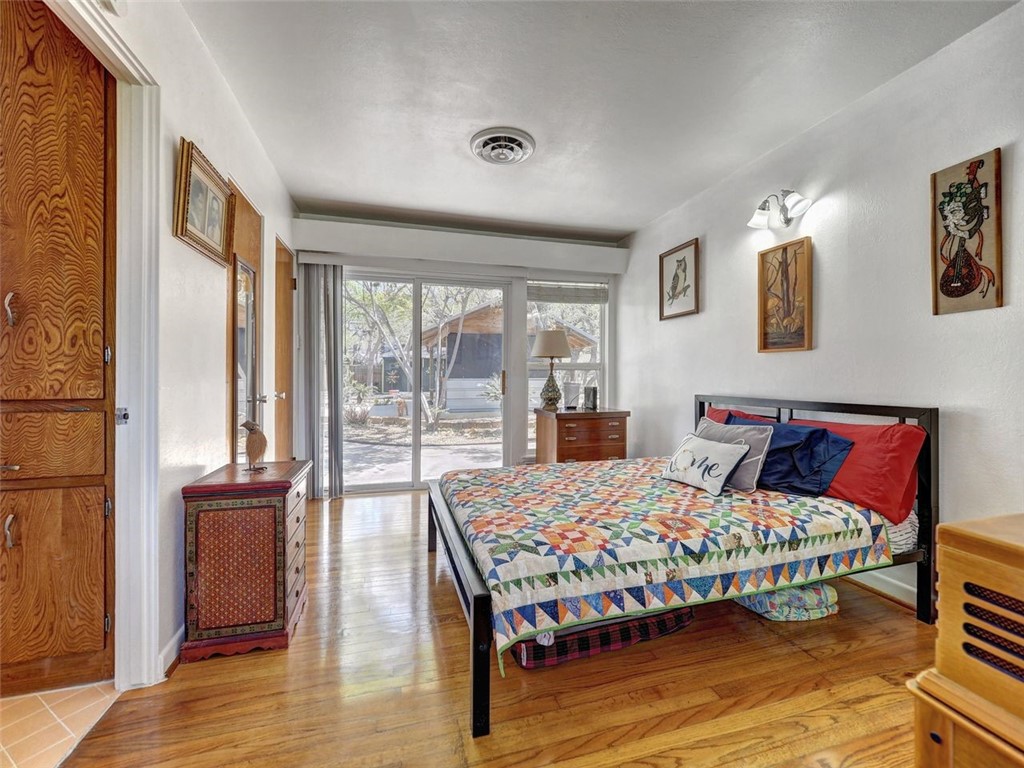 202 Sunset Ingleside, TX 78362 - Photo 20 of 40 a bedroom with a bed and wooden floor