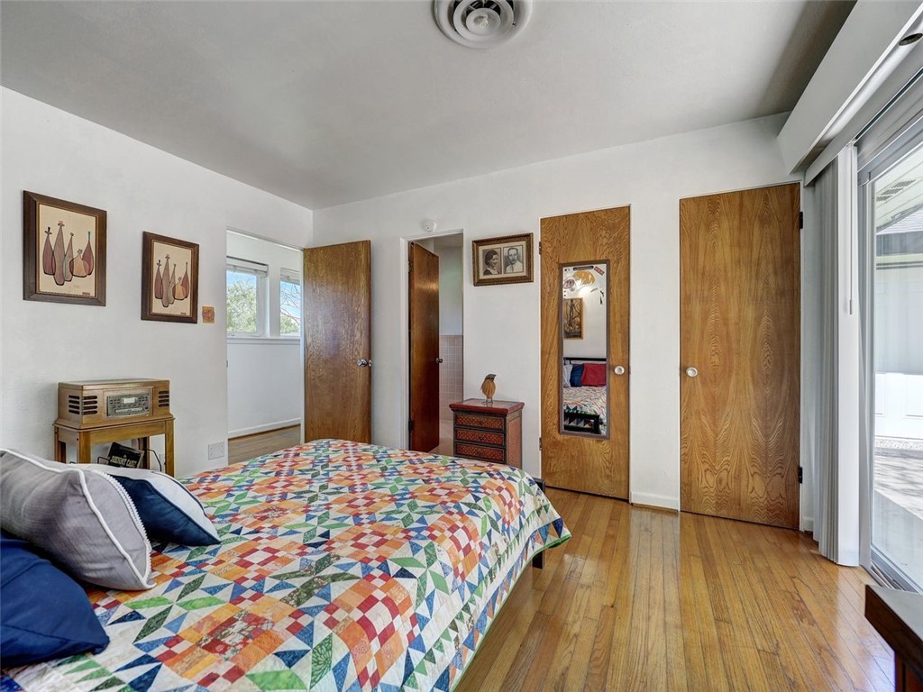 202 Sunset Ingleside, TX 78362 - Photo 21 of 40 a bedroom with a bed and wooden floor