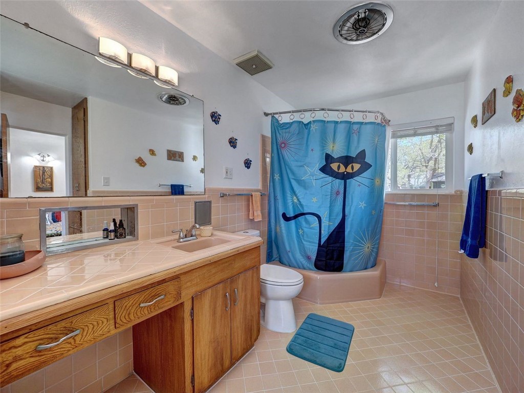 202 Sunset Ingleside, TX 78362 - Photo 22 of 40 a bathroom with a sink a mirror and a shower