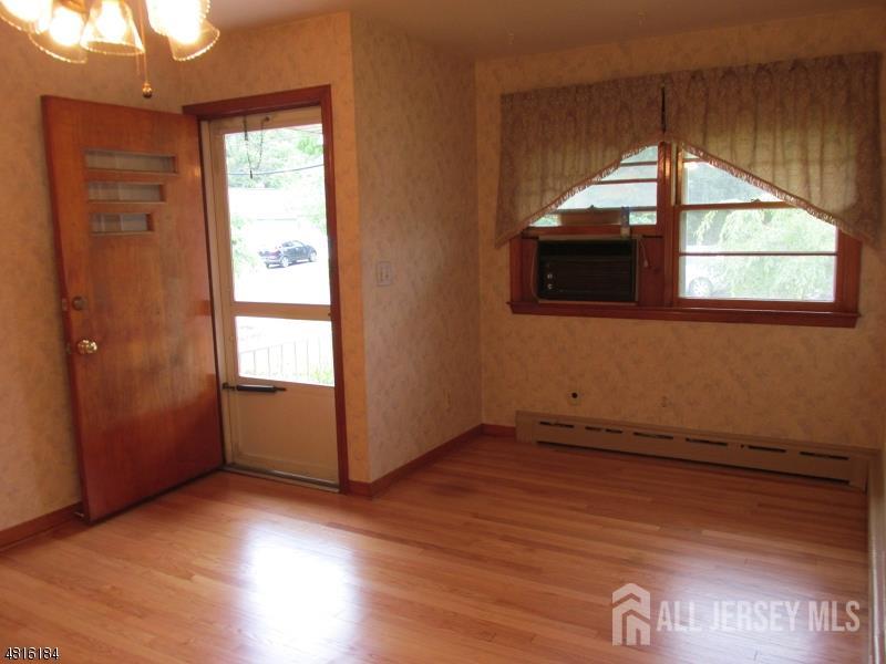 1818 West 4th Street Dunellen, NJ 08812 - Photo 4 of 7 an empty room with wooden floor and windows