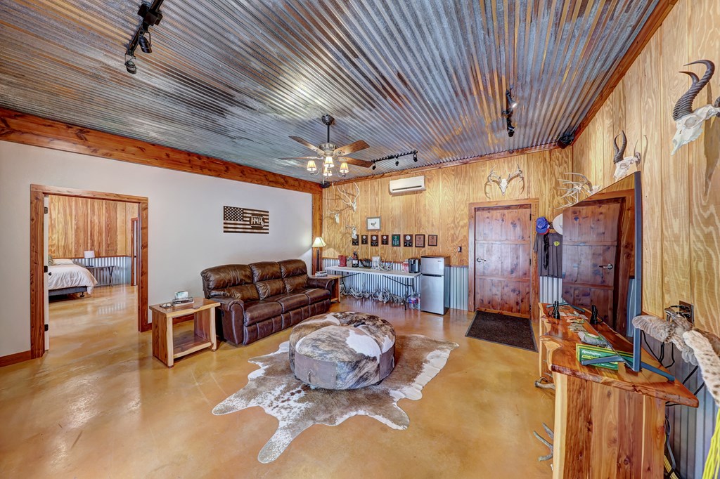 820 Bobby Shelton Ranch Road Northwest Mountain Home, TX 78058 - Photo 32 of 85 a living room with lots of furniture and a chandelier