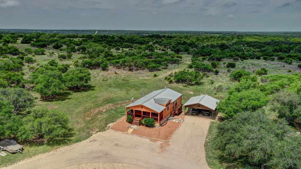 820 Bobby Shelton Ranch Road Northwest Mountain Home, TX 78058 - Photo 39 of 85 an aerial view of a house with a yard