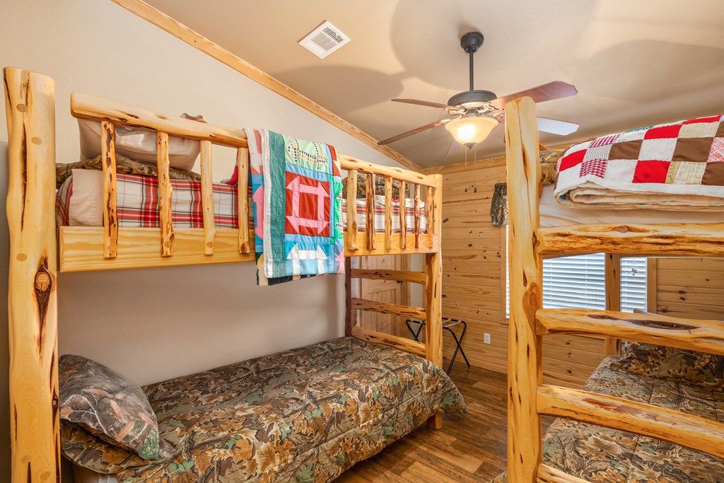 820 Bobby Shelton Ranch Road Northwest Mountain Home, TX 78058 - Photo 43 of 85 a bedroom with a bed dresser and a window