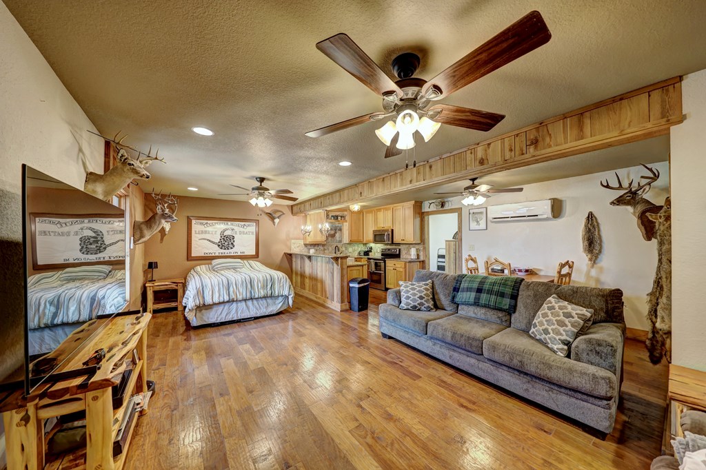 820 Bobby Shelton Ranch Road Northwest Mountain Home, TX 78058 - Photo 49 of 85 a living room with furniture and a flat screen tv