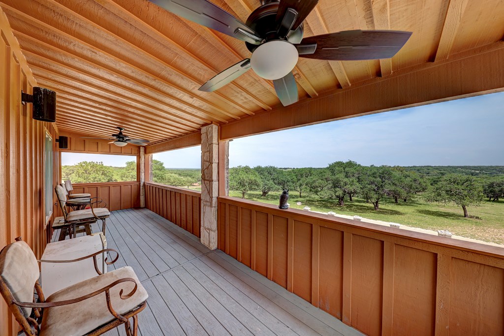 820 Bobby Shelton Ranch Road Northwest Mountain Home, TX 78058 - Photo 53 of 85 a view of a balcony with chairs and wooden floor