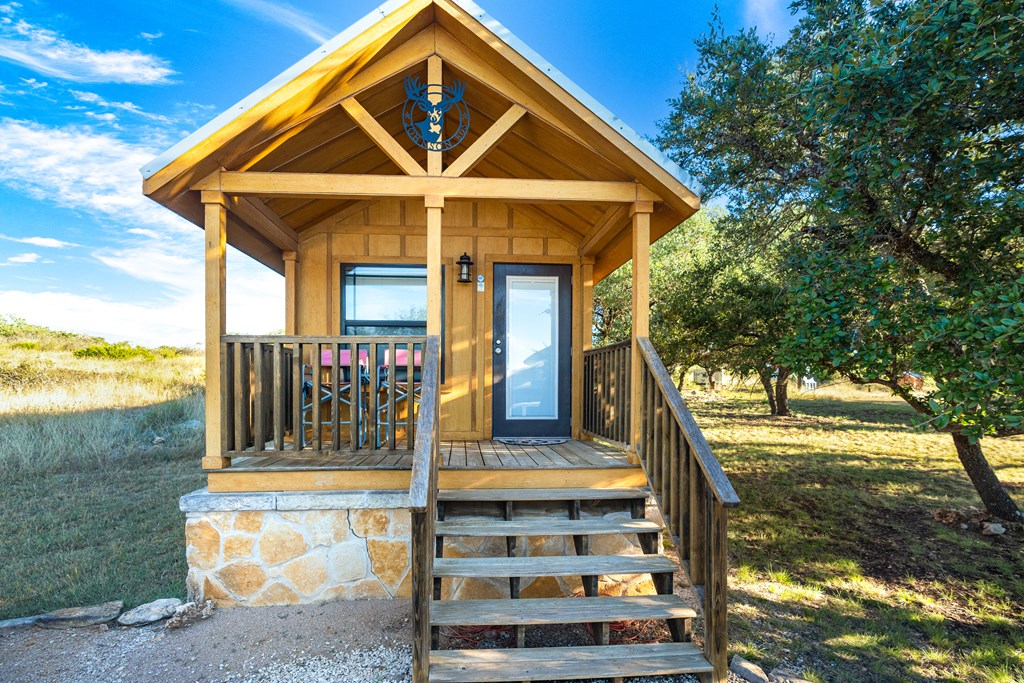 820 Bobby Shelton Ranch Road Northwest Mountain Home, TX 78058 - Photo 59 of 85 a front view of a house with a yard