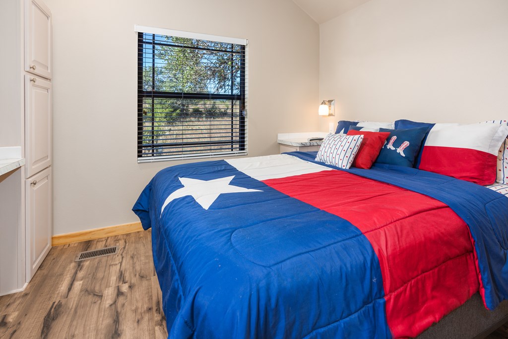 820 Bobby Shelton Ranch Road Northwest Mountain Home, TX 78058 - Photo 61 of 85 a bedroom with a bed and a window