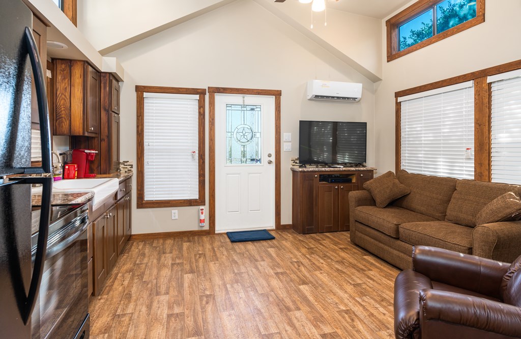 820 Bobby Shelton Ranch Road Northwest Mountain Home, TX 78058 - Photo 67 of 85 a living room with furniture and a flat screen tv