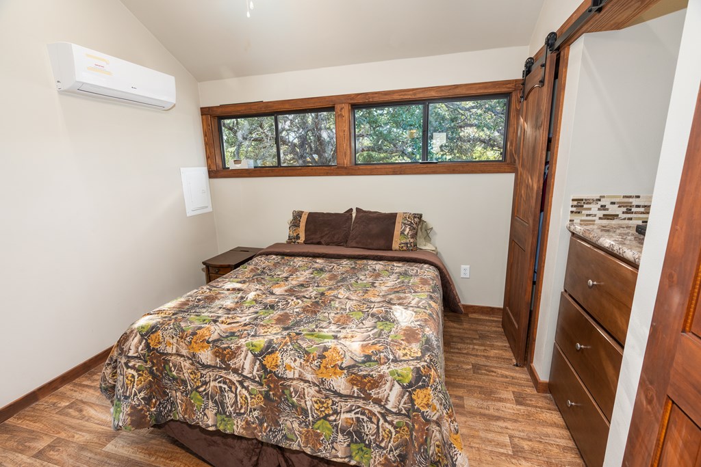 820 Bobby Shelton Ranch Road Northwest Mountain Home, TX 78058 - Photo 68 of 85 a bedroom with a bed and a window