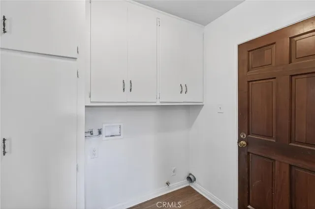a view of a room with wooden floor and a hallway