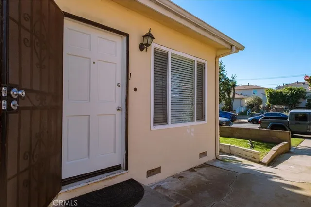 a view of a two chairs in the back yard of the house