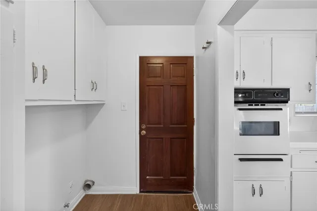 a kitchen with white cabinets and white appliances