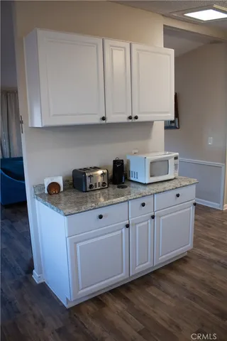 a kitchen with stainless steel appliances granite countertop a sink and a white cabinets