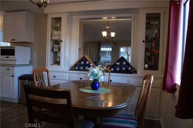 a dining room with furniture and wooden floor
