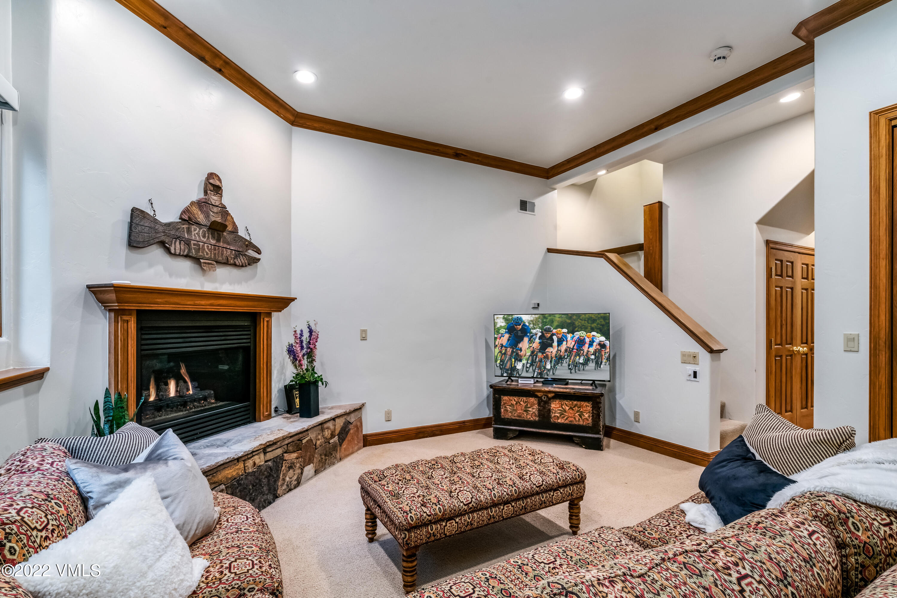 355 Forest Road, Unit B Vail, CO 81657 - Photo 24 of 36 a living room with furniture and a fireplace