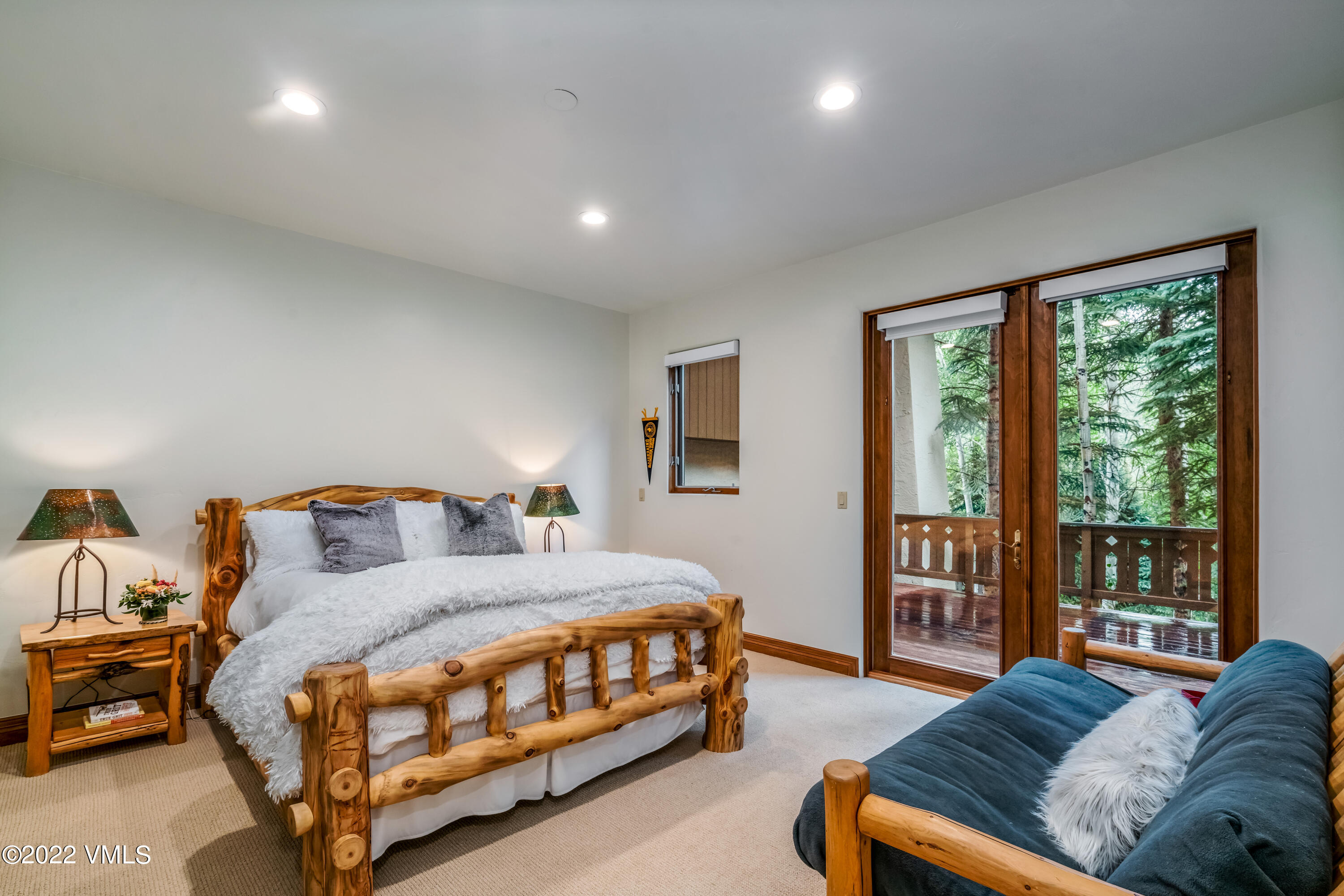 355 Forest Road, Unit B Vail, CO 81657 - Photo 25 of 36 a bedroom with a bed couch and a large window