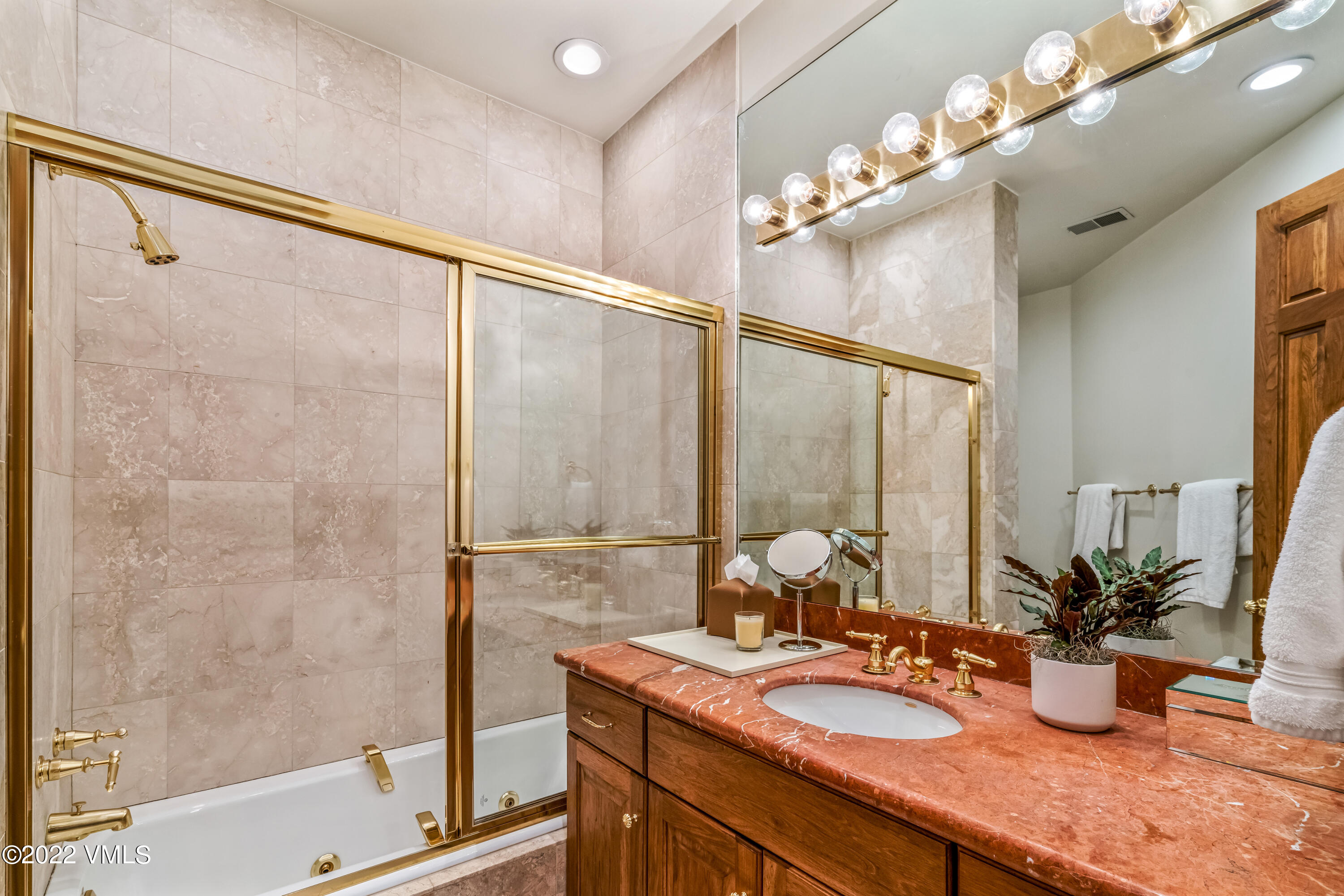 355 Forest Road, Unit B Vail, CO 81657 - Photo 26 of 36 a bathroom with a granite countertop sink a mirror and a shower