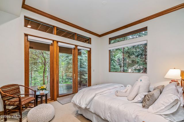 a bedroom with a bed and glass windows