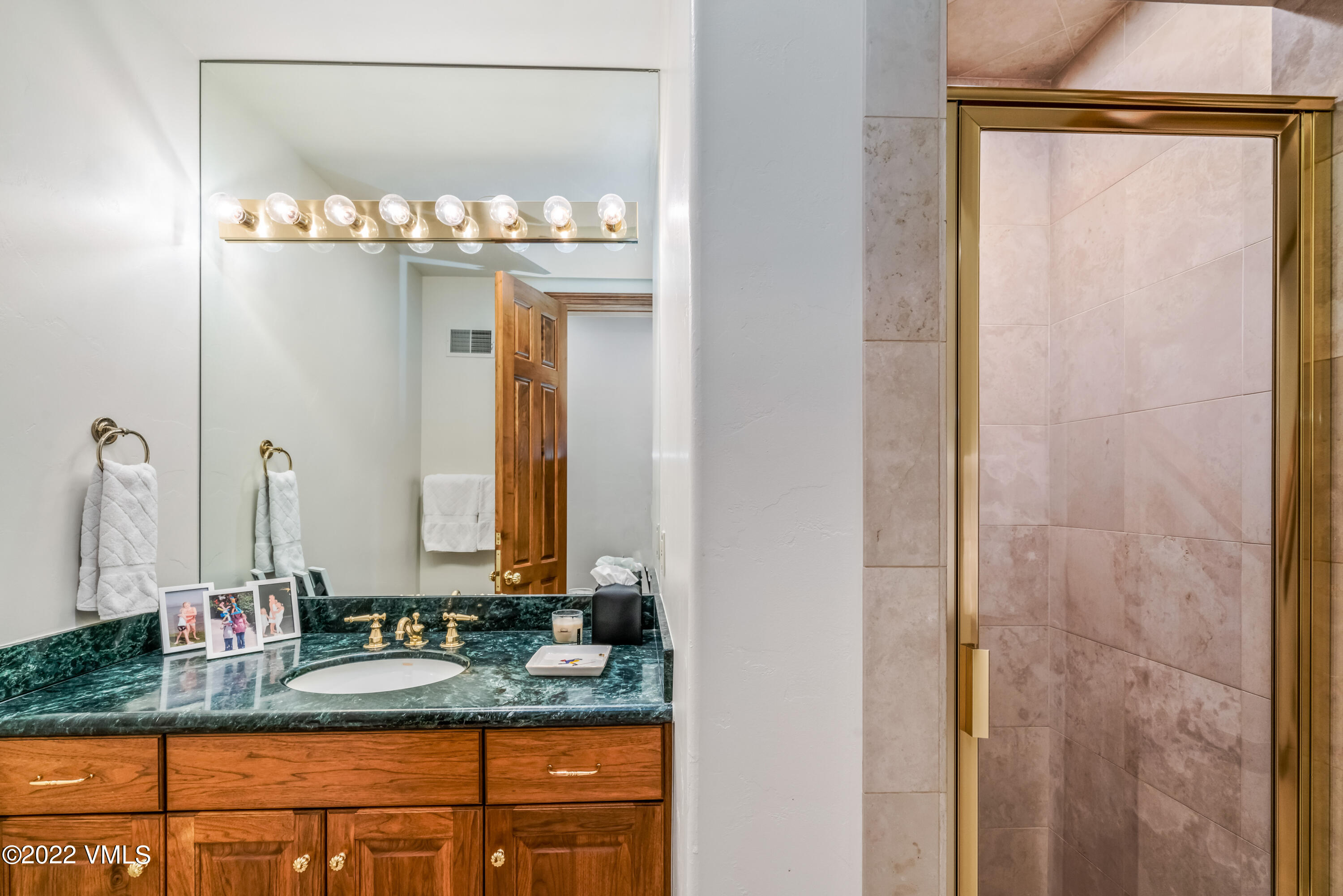 355 Forest Road, Unit B Vail, CO 81657 - Photo 28 of 36 a bathroom with a sink and a mirror