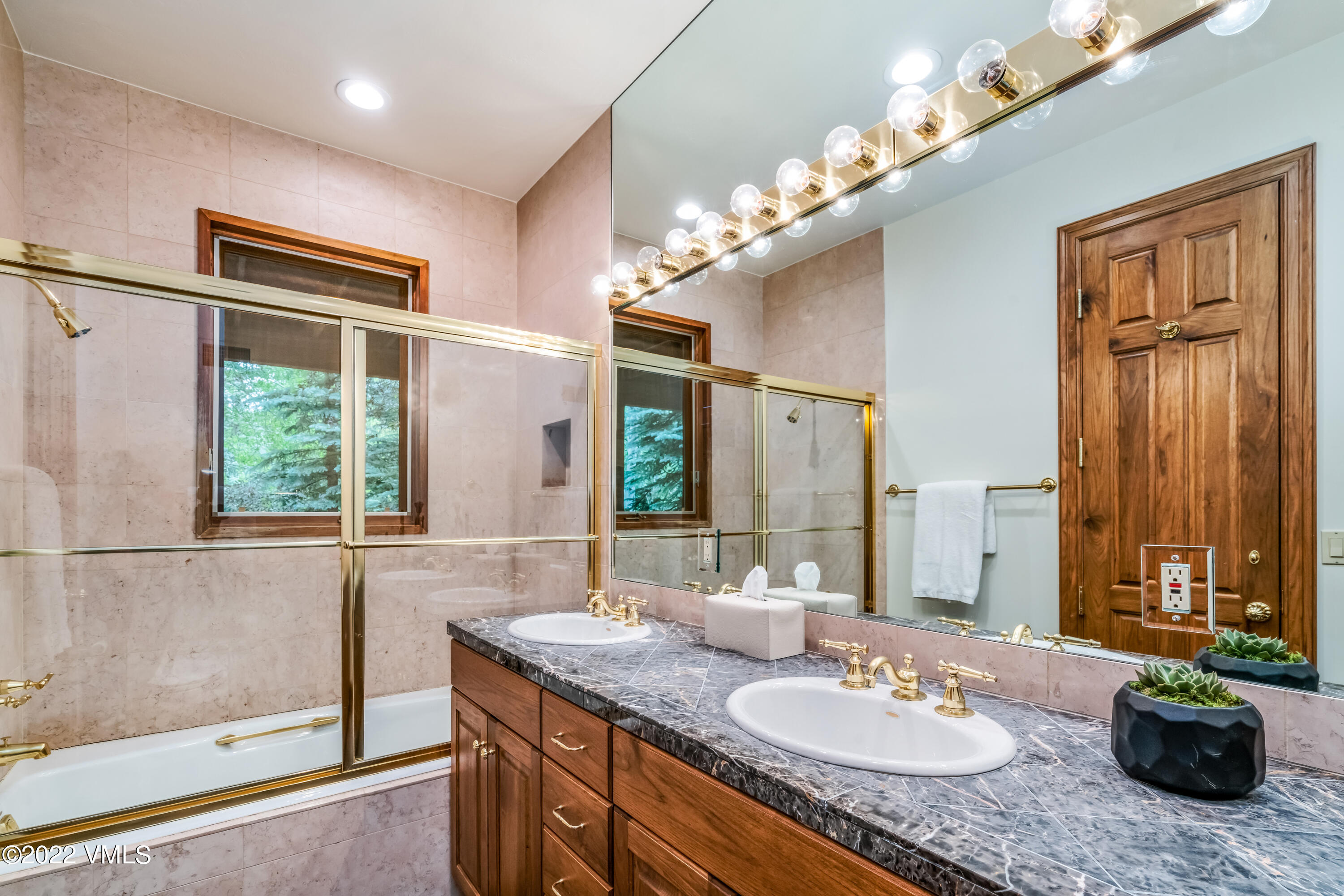 355 Forest Road, Unit B Vail, CO 81657 - Photo 30 of 36 a bathroom with a granite countertop sink a large mirror and a shower