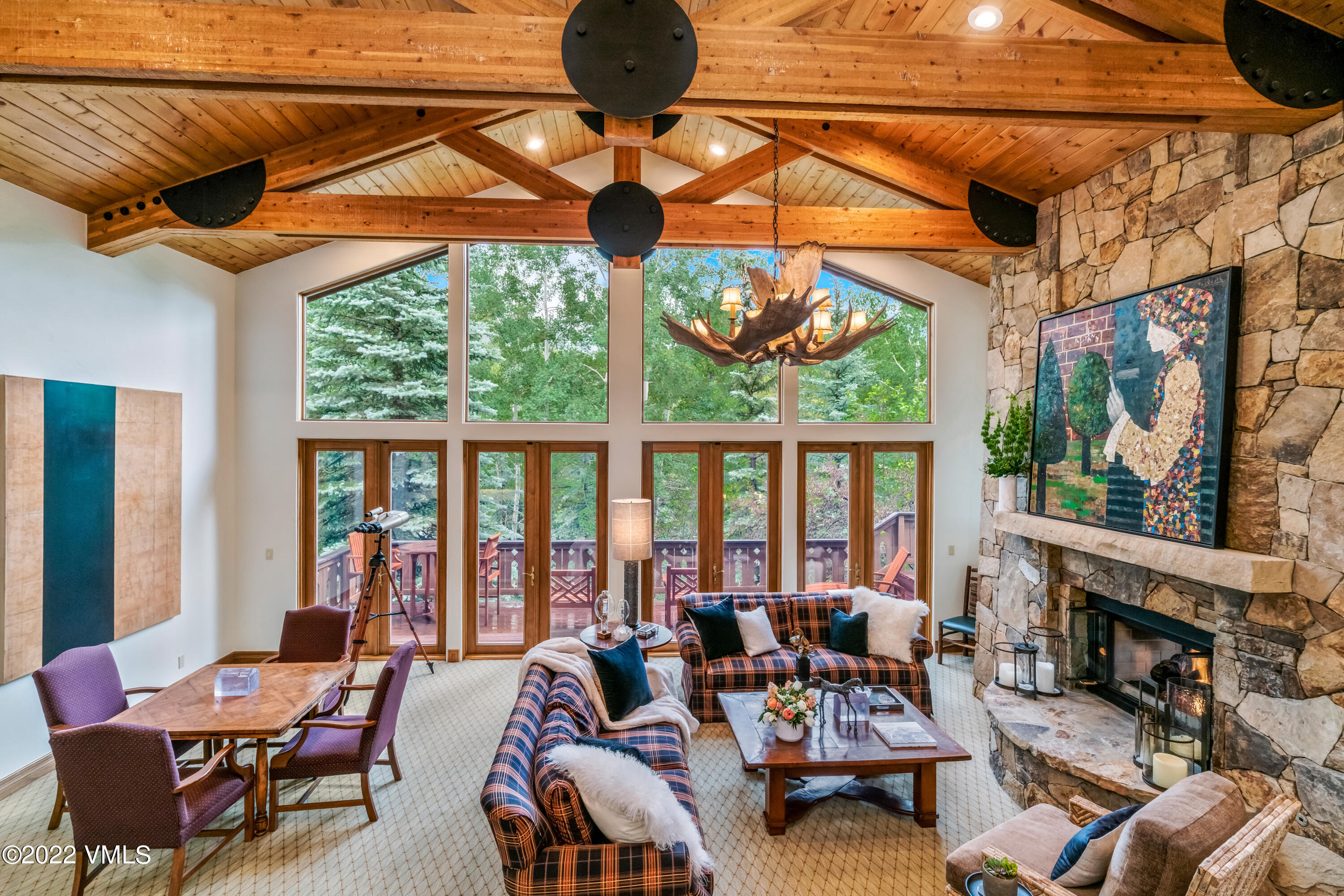 355 Forest Road, Unit B Vail, CO 81657 - Photo 3 of 36 a living room with furniture a fireplace and floor to ceiling windows