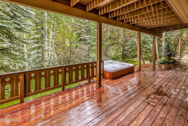 a balcony with wooden floor and outdoor space