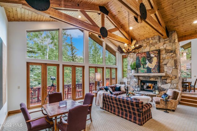 a living room with furniture a fireplace and a large window