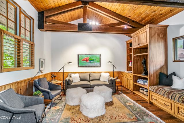 a roof deck with couch and chairs