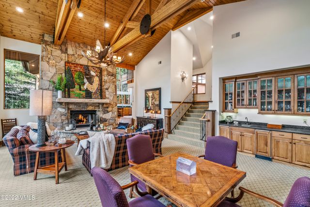 a living room with furniture a fireplace and a large window
