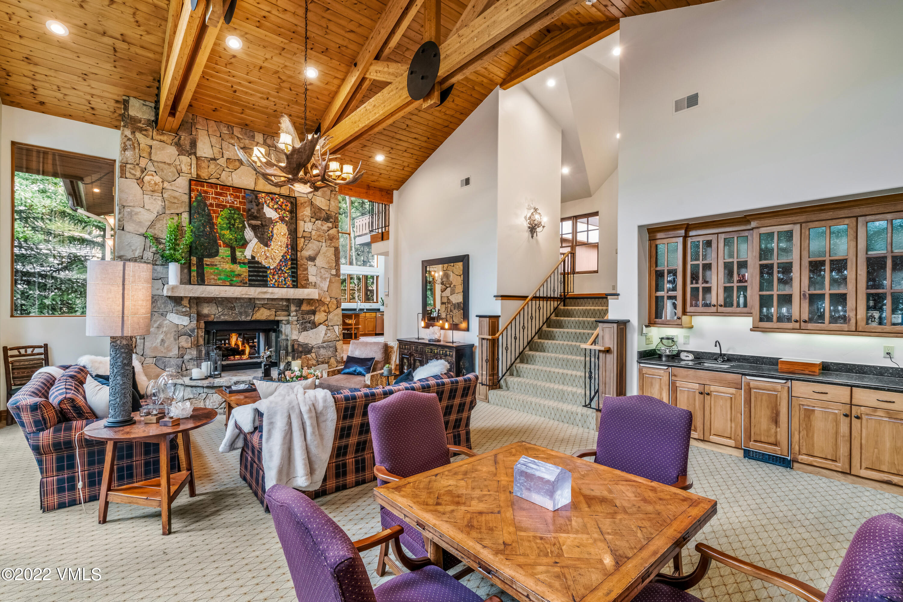 355 Forest Road, Unit B Vail, CO 81657 - Photo 9 of 36 a living room with furniture a fireplace and a large window