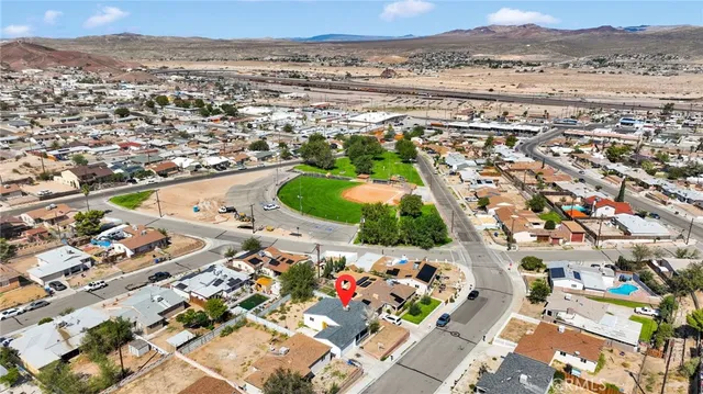 an aerial view of a house with a yard
