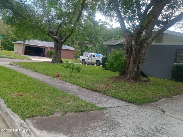a front view of a house with garden