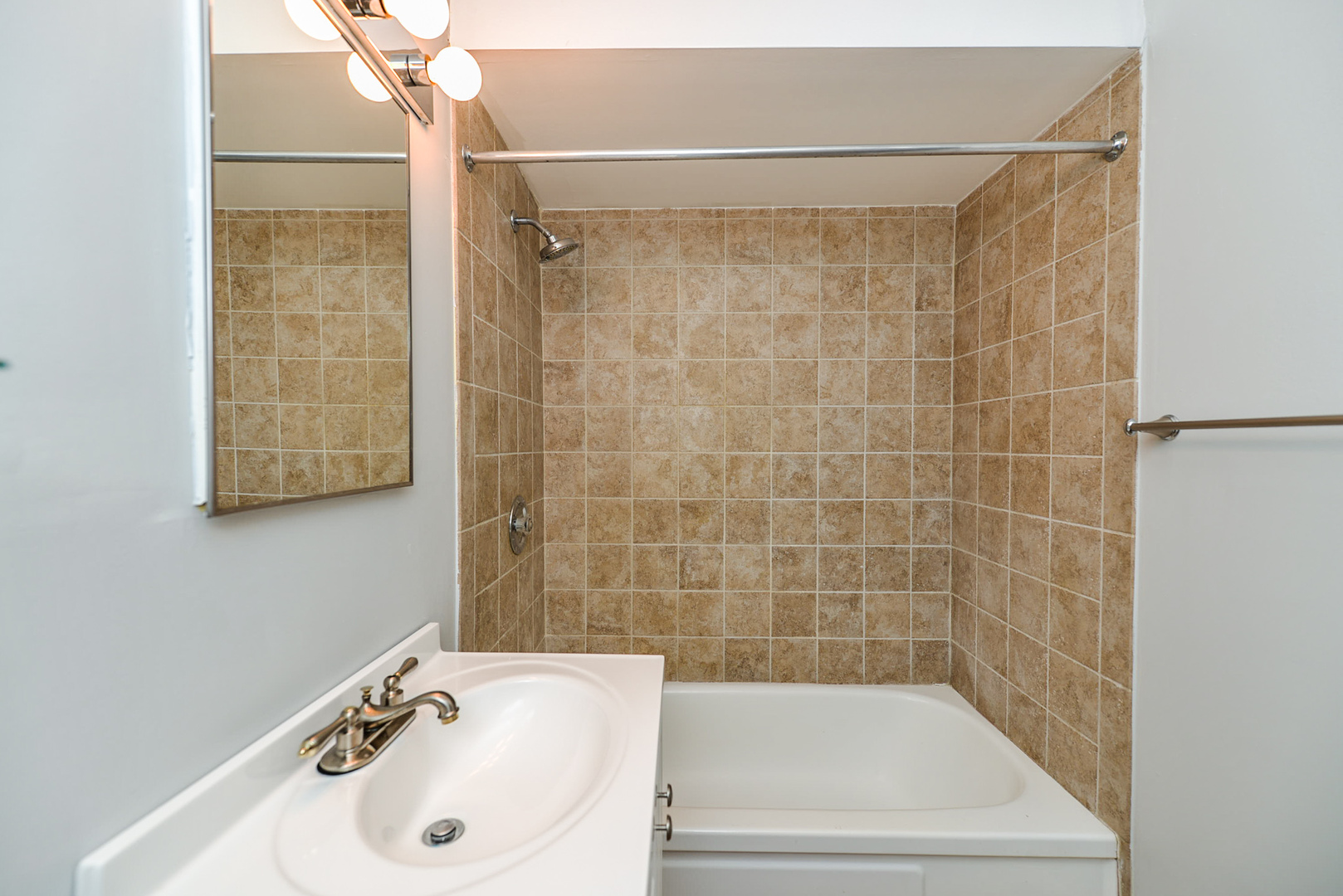 2234 South Goebbert Road, Unit 320 Arlington Heights, IL 60005 - Photo 19 of 37 a bathroom with a sink and a bathtub