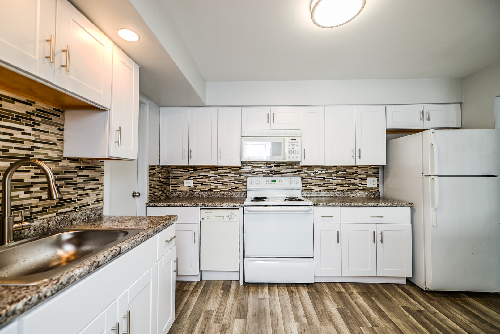 2234 South Goebbert Road, Unit 320 Arlington Heights, IL 60005 - Photo 2 of 37 a kitchen with a sink stove and refrigerator
