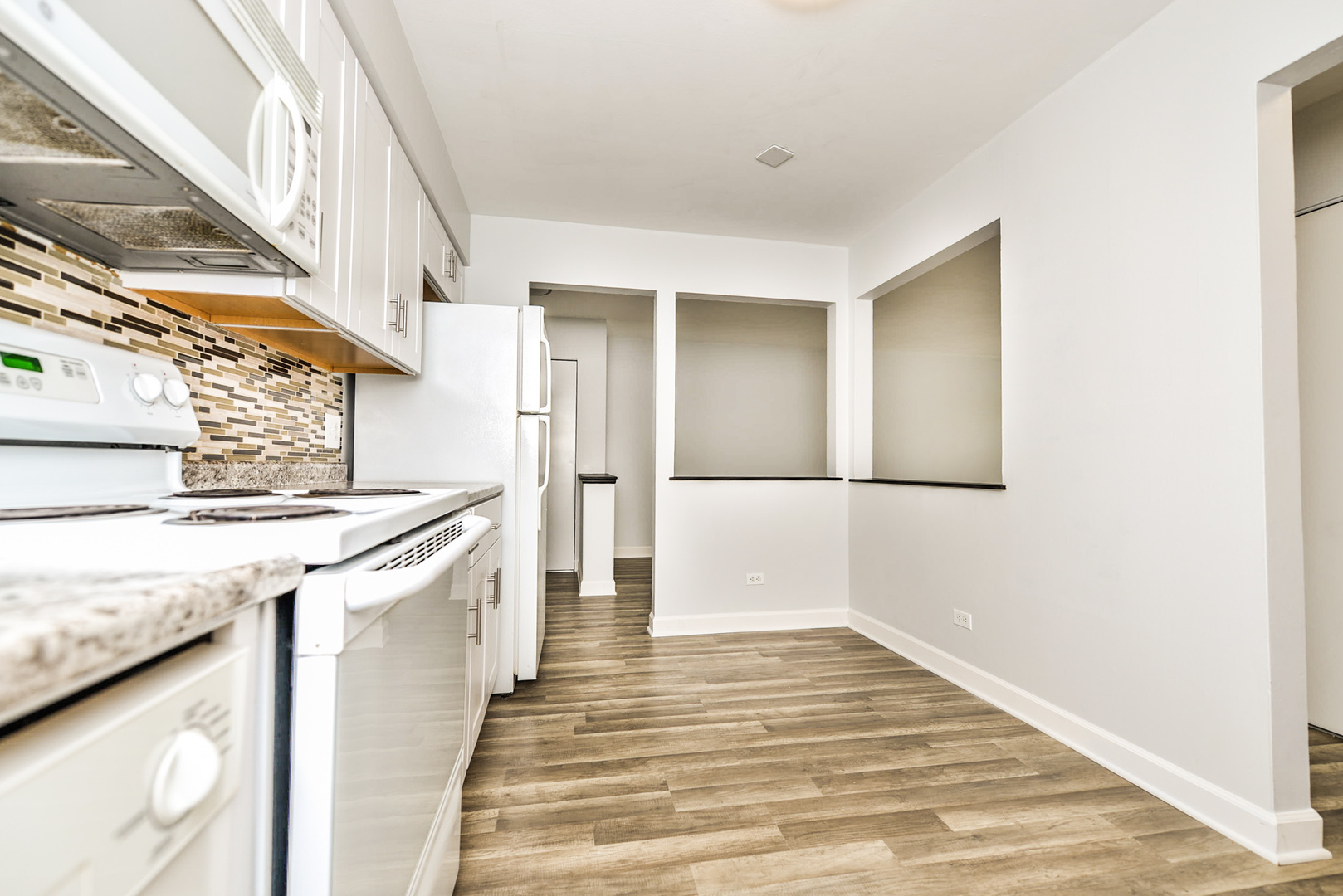 2234 South Goebbert Road, Unit 320 Arlington Heights, IL 60005 - Photo 4 of 37 a view of a kitchen cabinets a sink and wooden floor