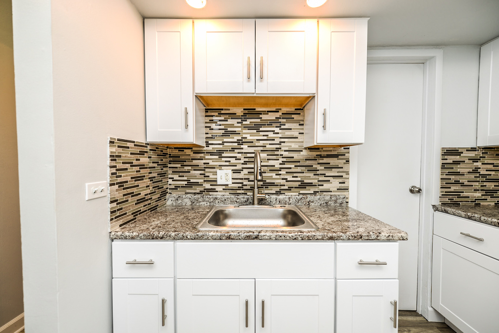 2234 South Goebbert Road, Unit 320 Arlington Heights, IL 60005 - Photo 5 of 37 a bathroom with a granite countertop sink and a mirror