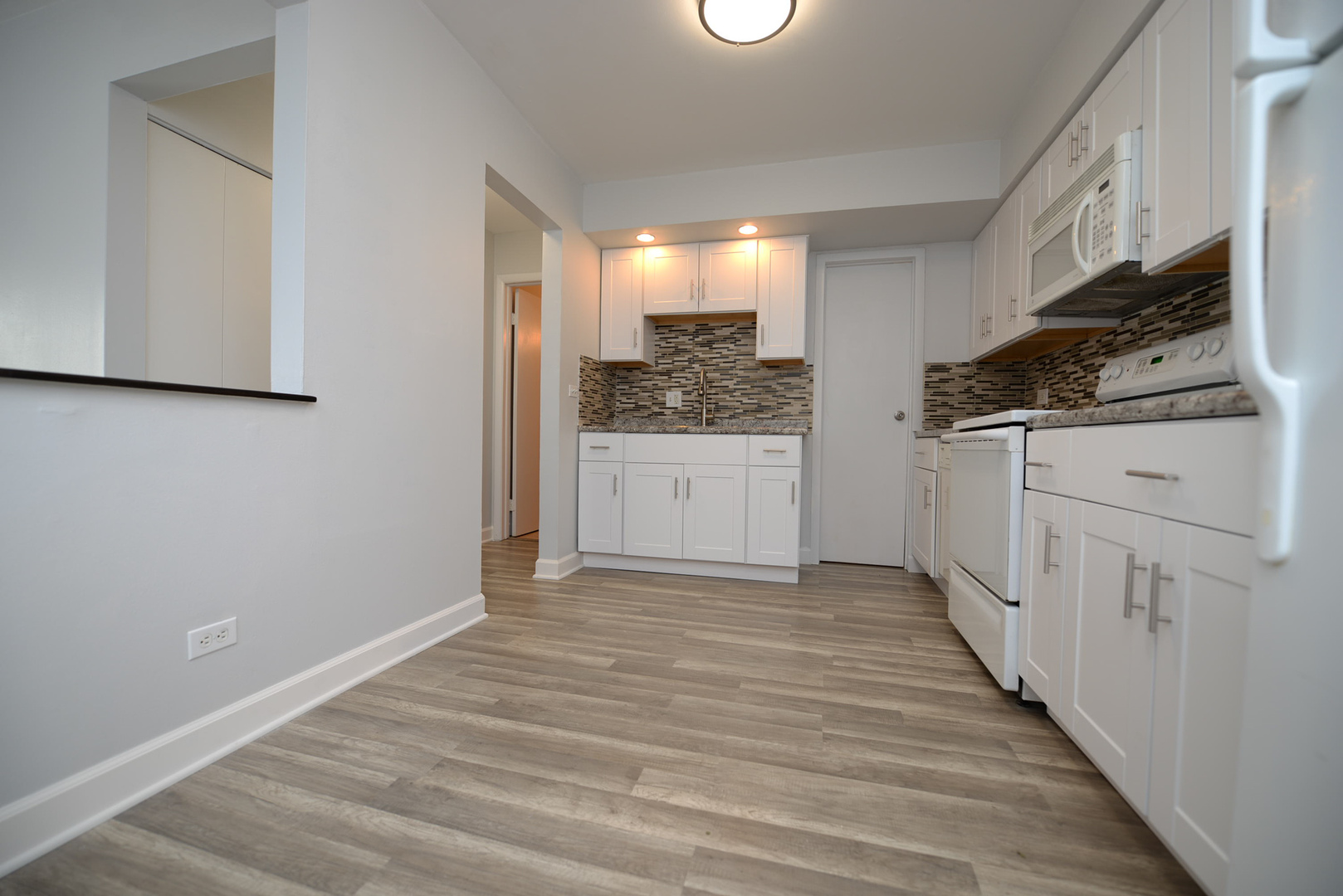 2234 South Goebbert Road, Unit 320 Arlington Heights, IL 60005 - Photo 7 of 37 a view of a kitchen with a sink