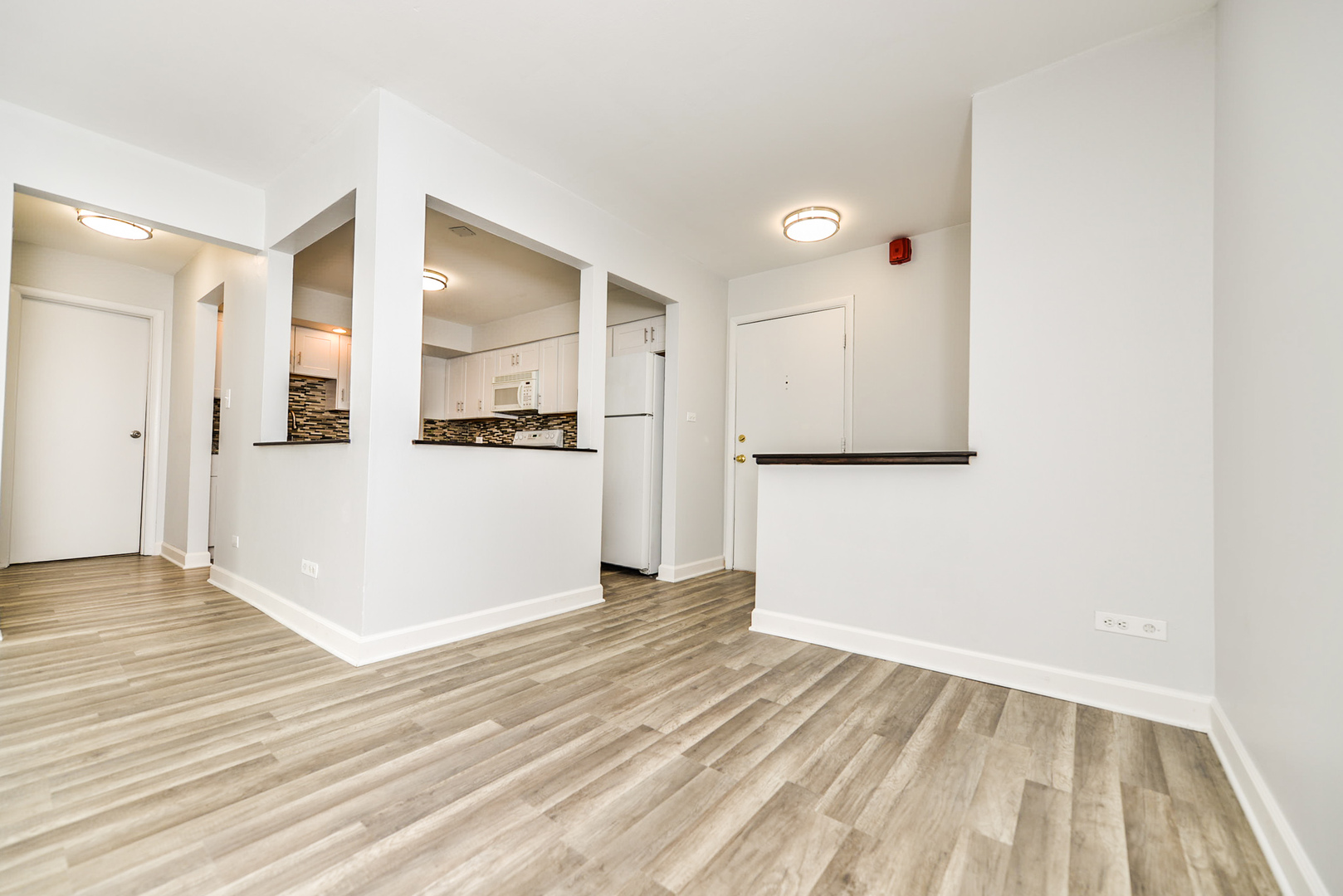 2234 South Goebbert Road, Unit 320 Arlington Heights, IL 60005 - Photo 9 of 37 an empty room with wooden floor and windows
