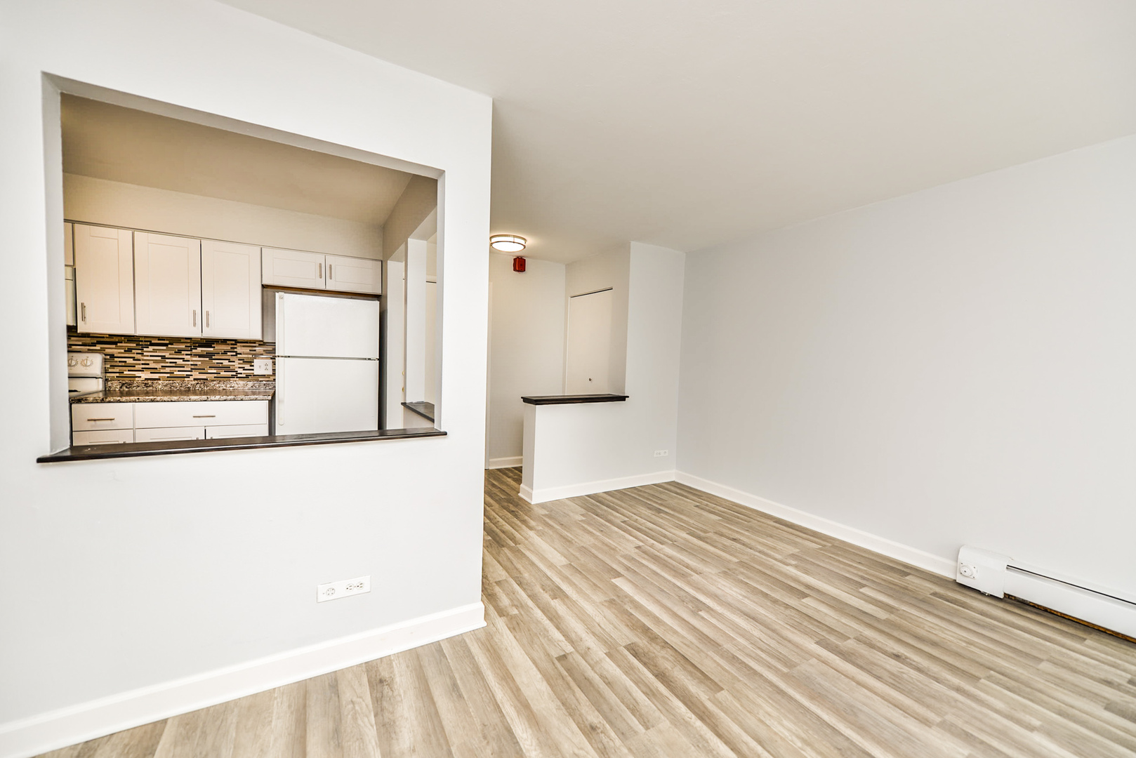 2234 South Goebbert Road, Unit 320 Arlington Heights, IL 60005 - Photo 10 of 37 wooden floor in a white room