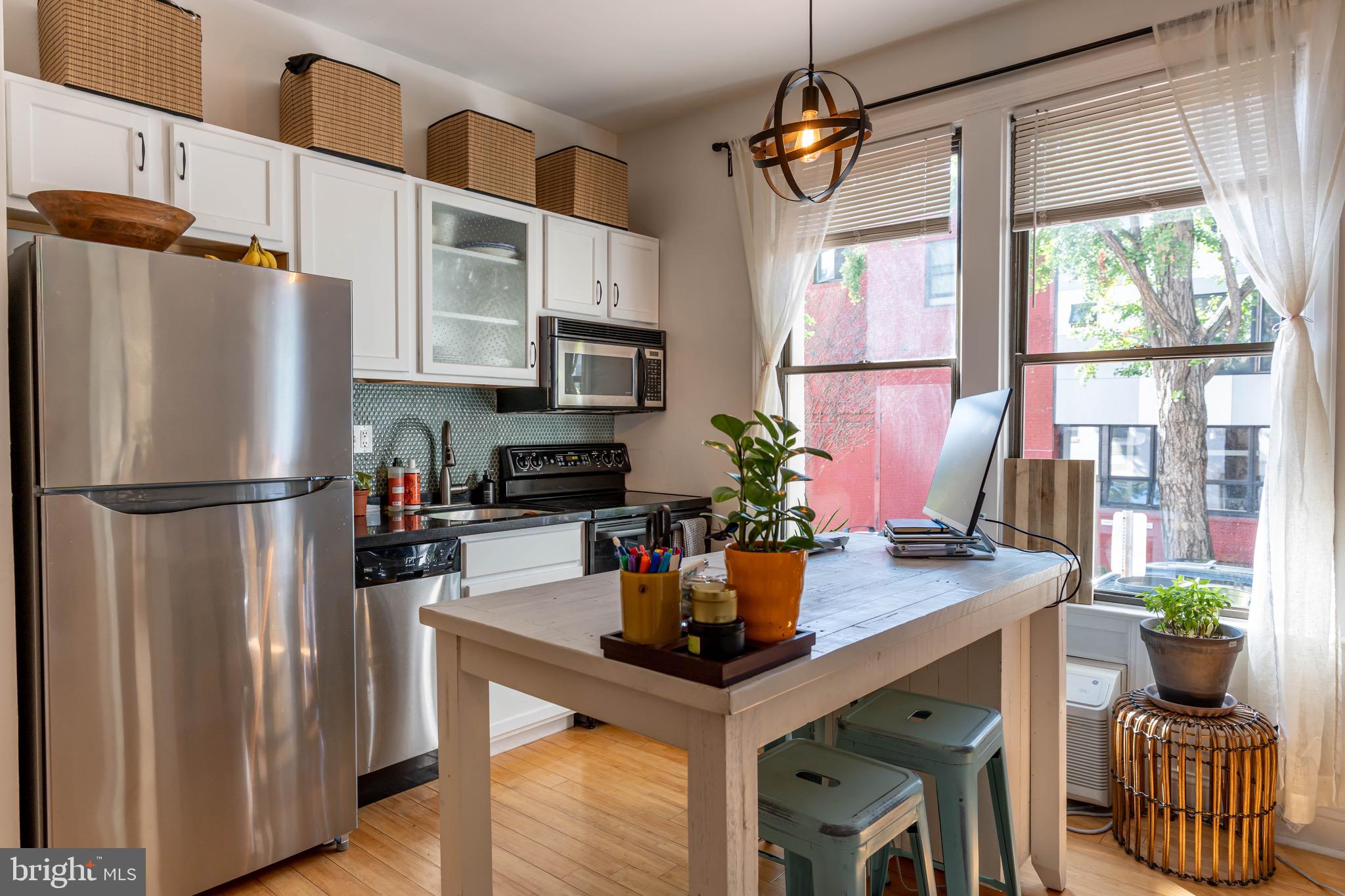 a kitchen with stainless steel appliances granite countertop a refrigerator and a sink