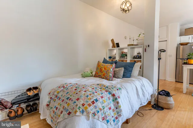 a bedroom with a bed and a chandelier