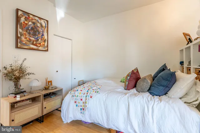 a bedroom with a bed and a potted plant