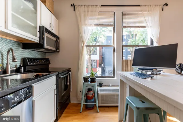 a kitchen with stainless steel appliances a stove a sink and a refrigerator