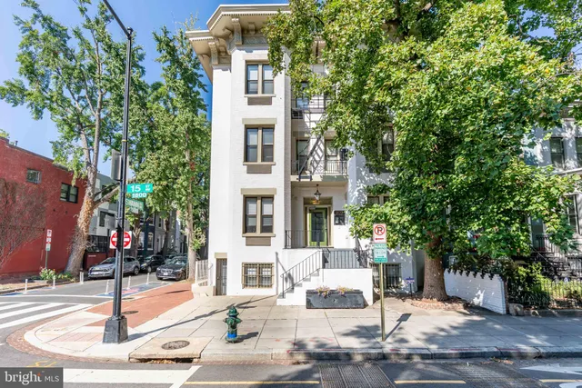 front view of a building with a tree