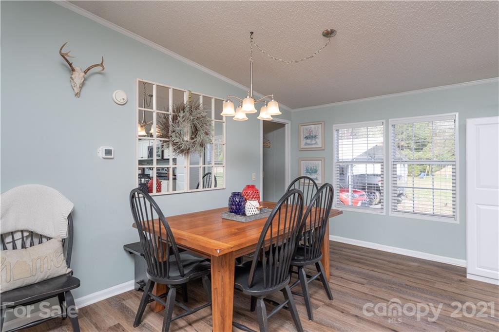 854 West Rambo Road Rock Hill, SC 29730 - Photo 13 of 27 a dining room with furniture a chandelier and wooden floor