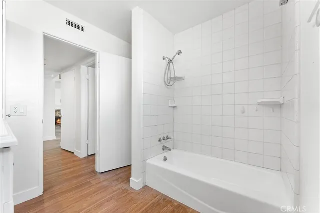 a bathroom with a bathtub and shower